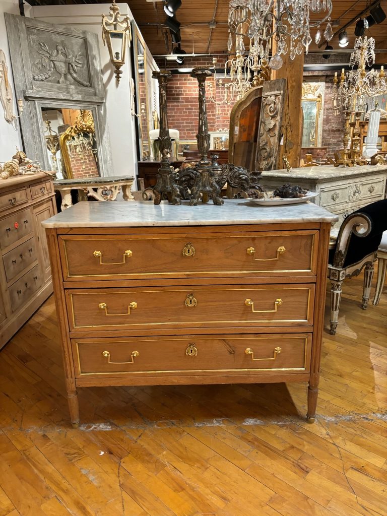 Antique wood dresser with gold handles.
